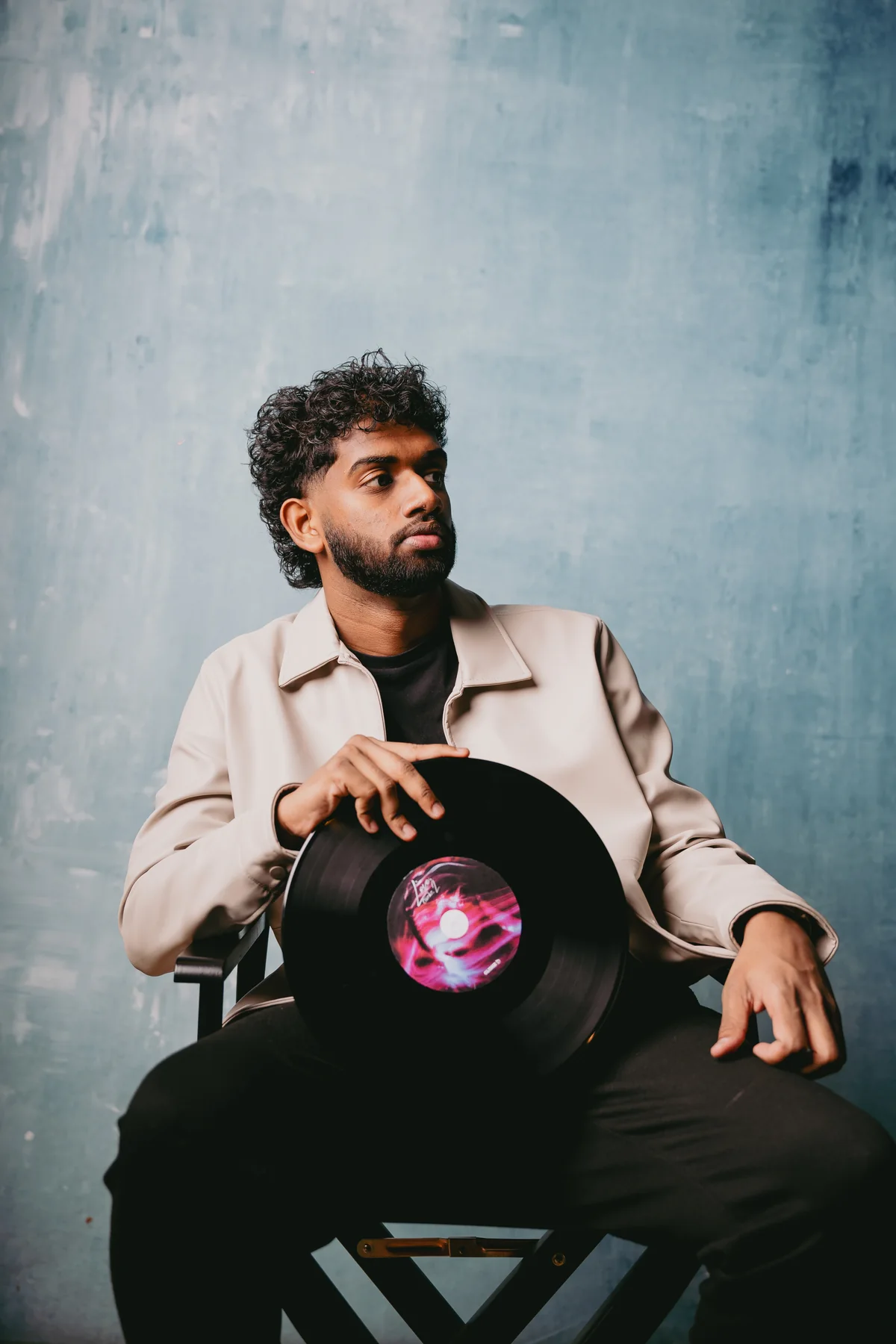 DJ Clickz holding a vinyl record